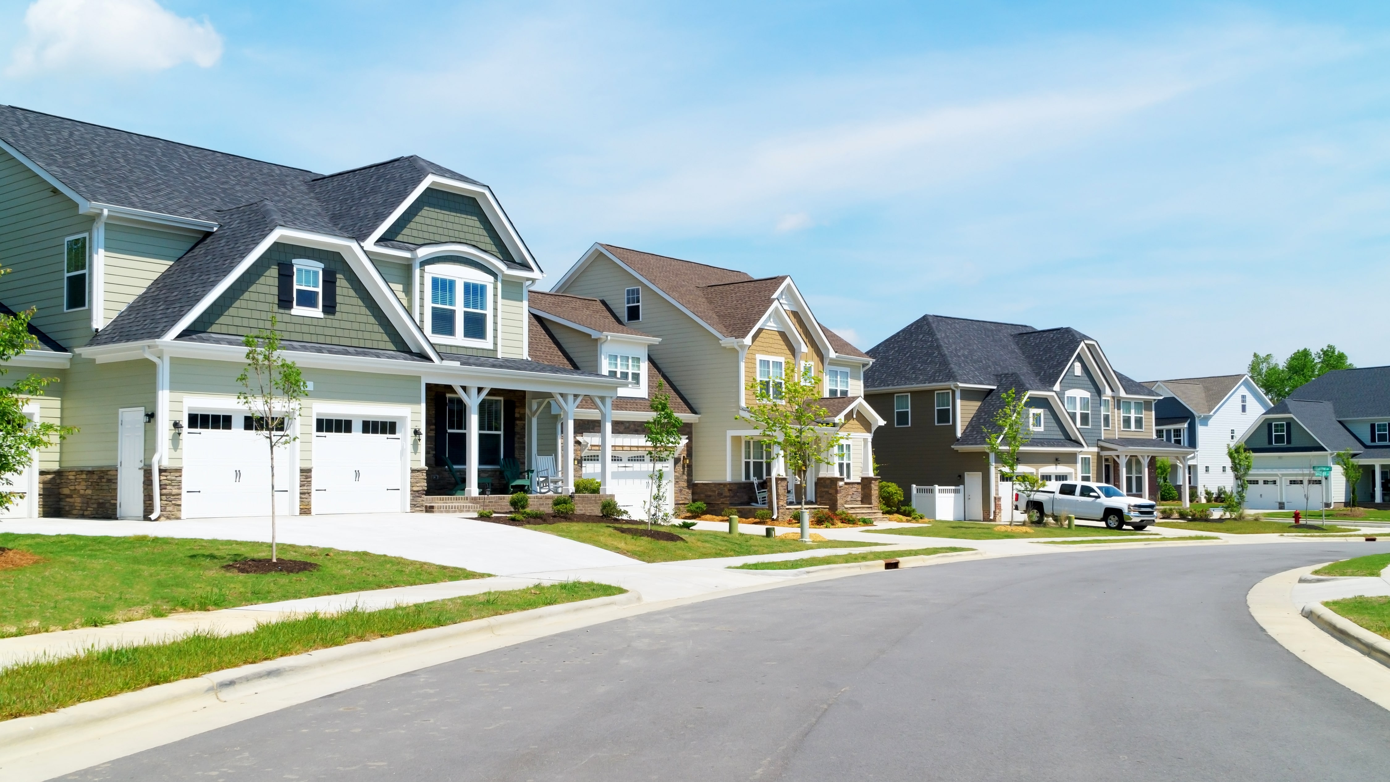 A beautiful suburban street with modern, well-maintained homes.