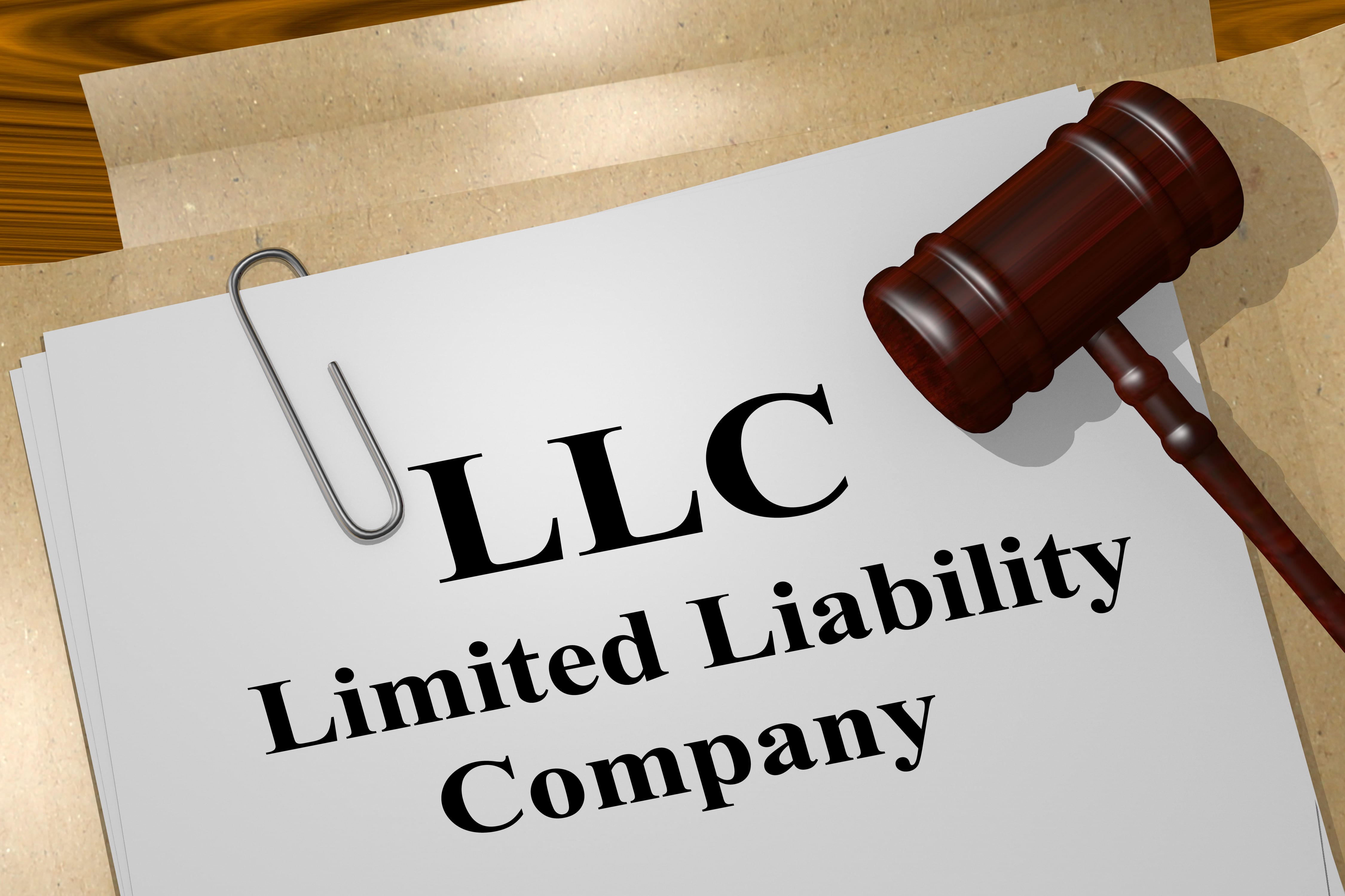 A document titled ‘LLC Limited Liability Company’ with a gavel resting on top, symbolizing legal and business processes for LLC formation.