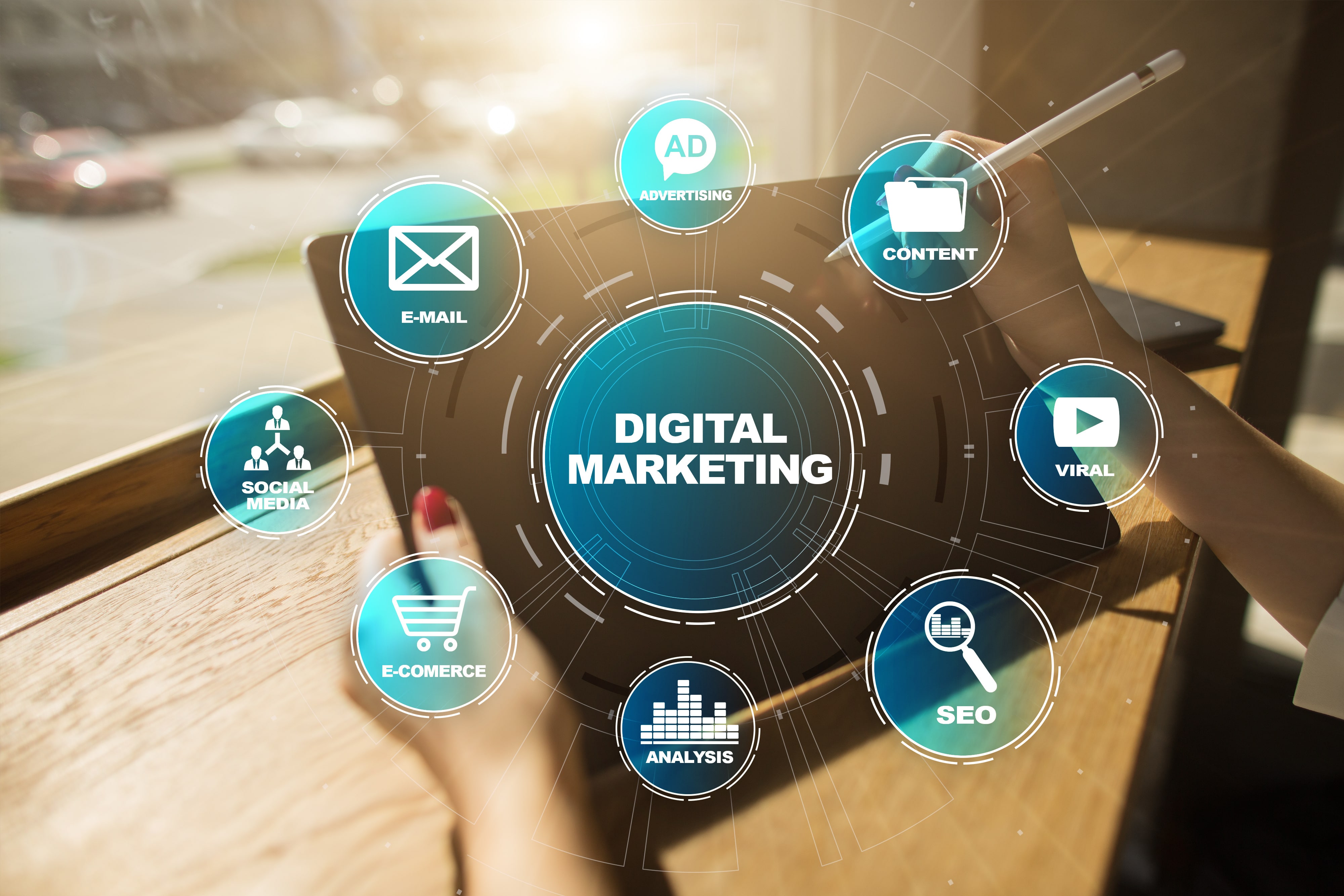 Digital marketing strategy concept with interconnected icons representing email marketing, advertising, content creation, SEO, social media, e-commerce, and analysis, overlaid on a tablet screen.