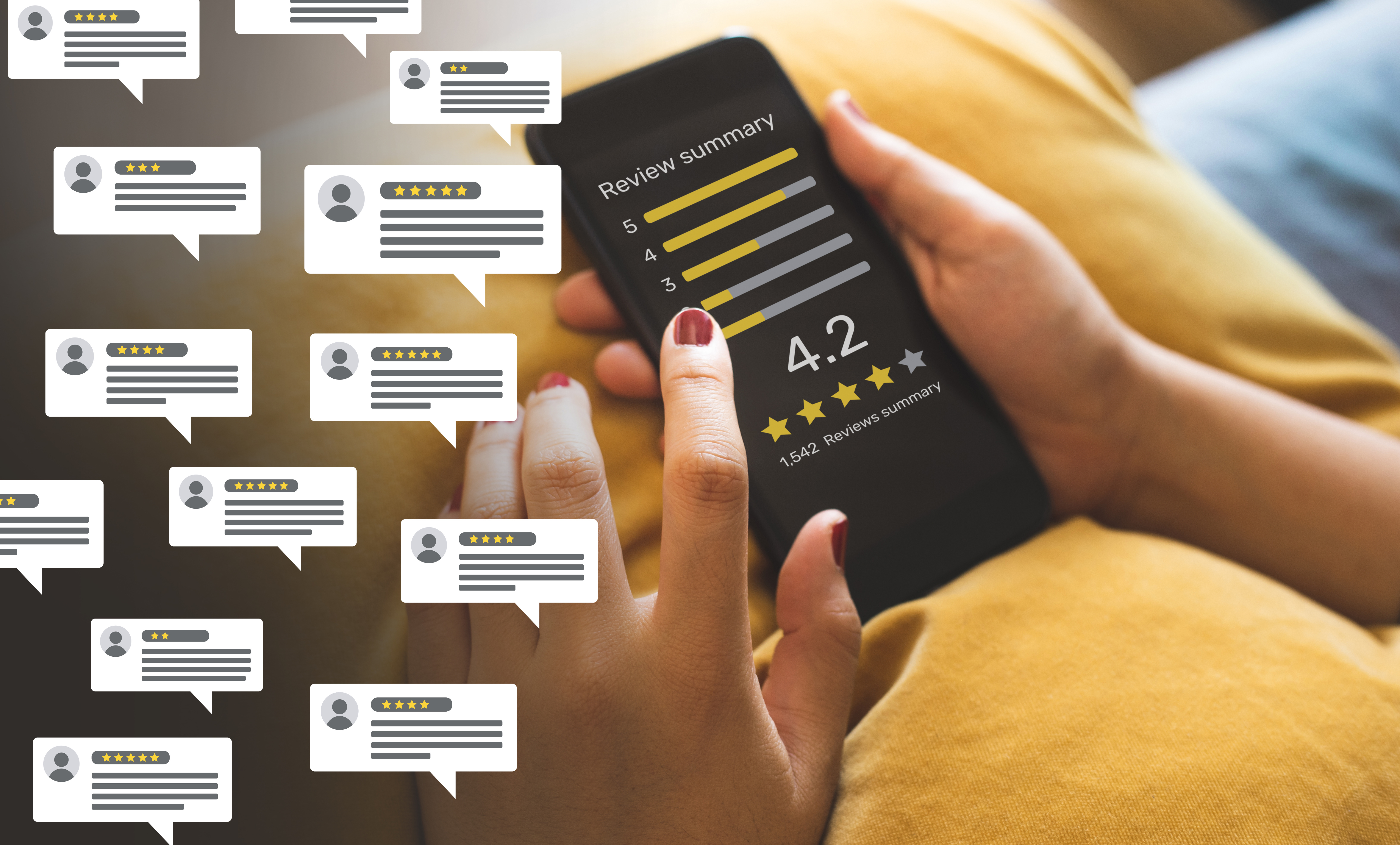 A hand is holding a smartphone, which displays a review summary of 4.2 stars out of 5, based on 1,542 reviews. Speech bubbles representing various reviews with different star ratings float around the screen, indicating customer feedback.