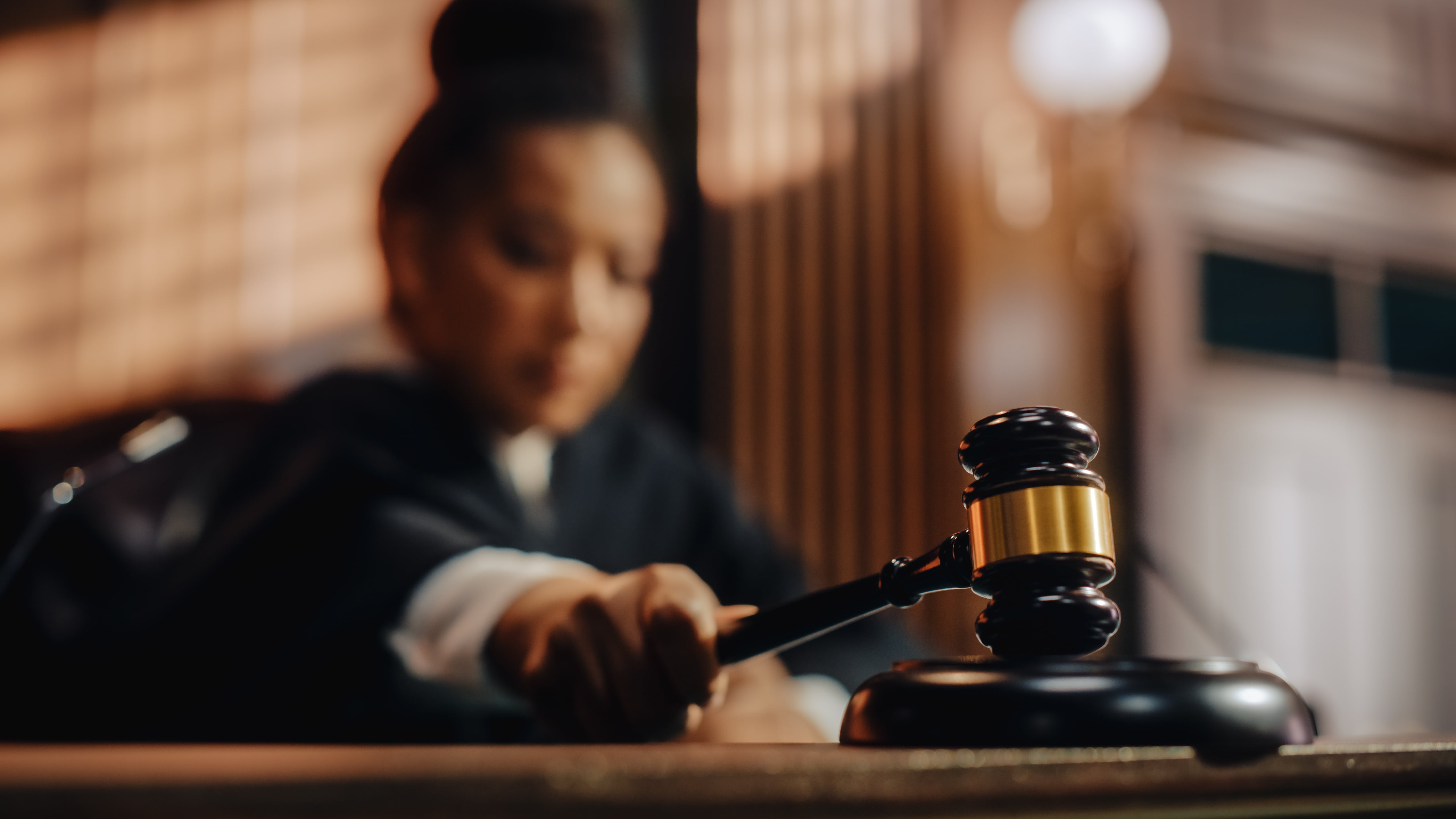 A judge striking a gavel in a courtroom, symbolizing the legal process of eviction and tenant disputes.