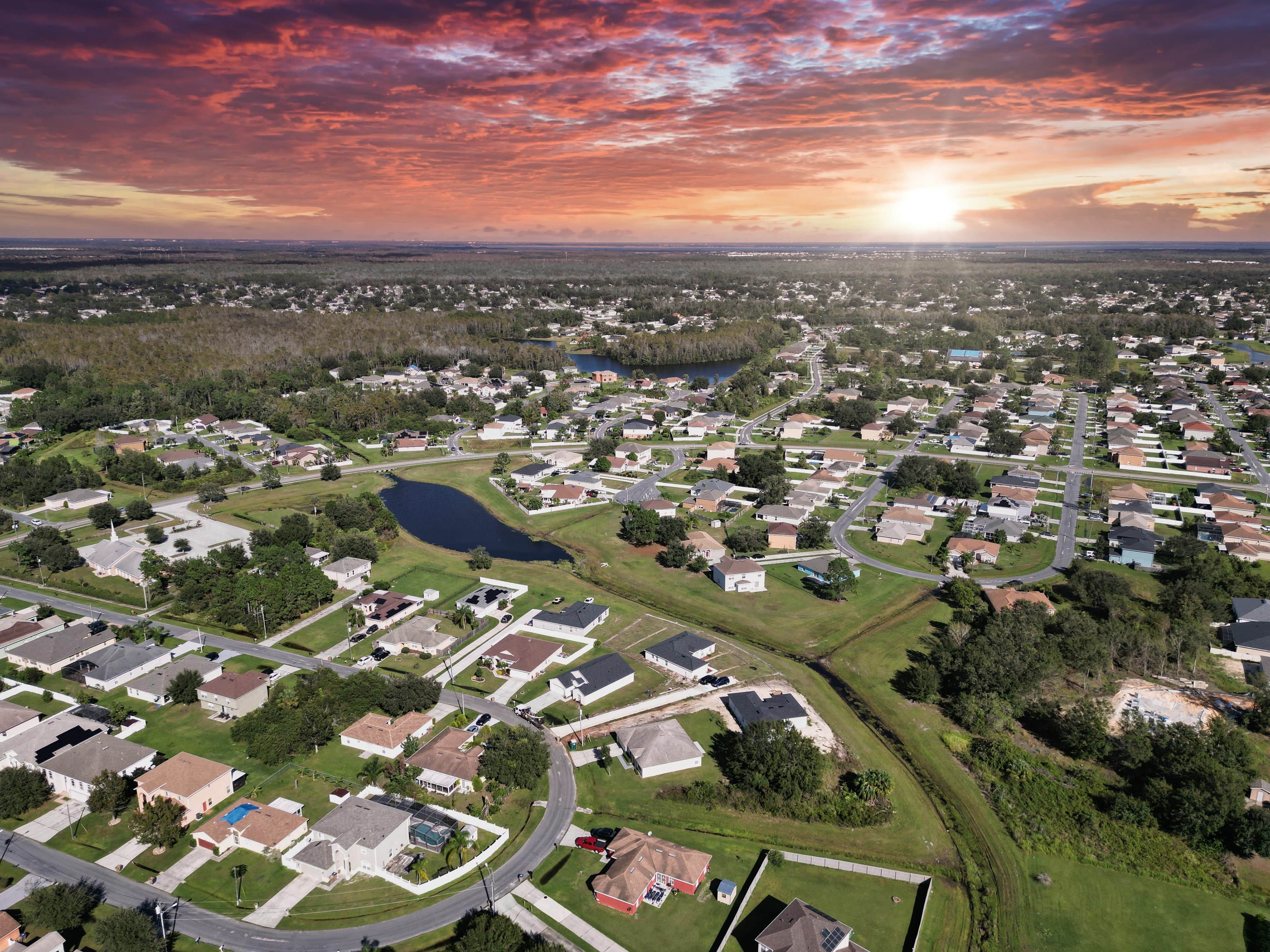 Aerial view of a suburban neighborhood with winding roads and lakes, representing residential property investments in Central Florida.