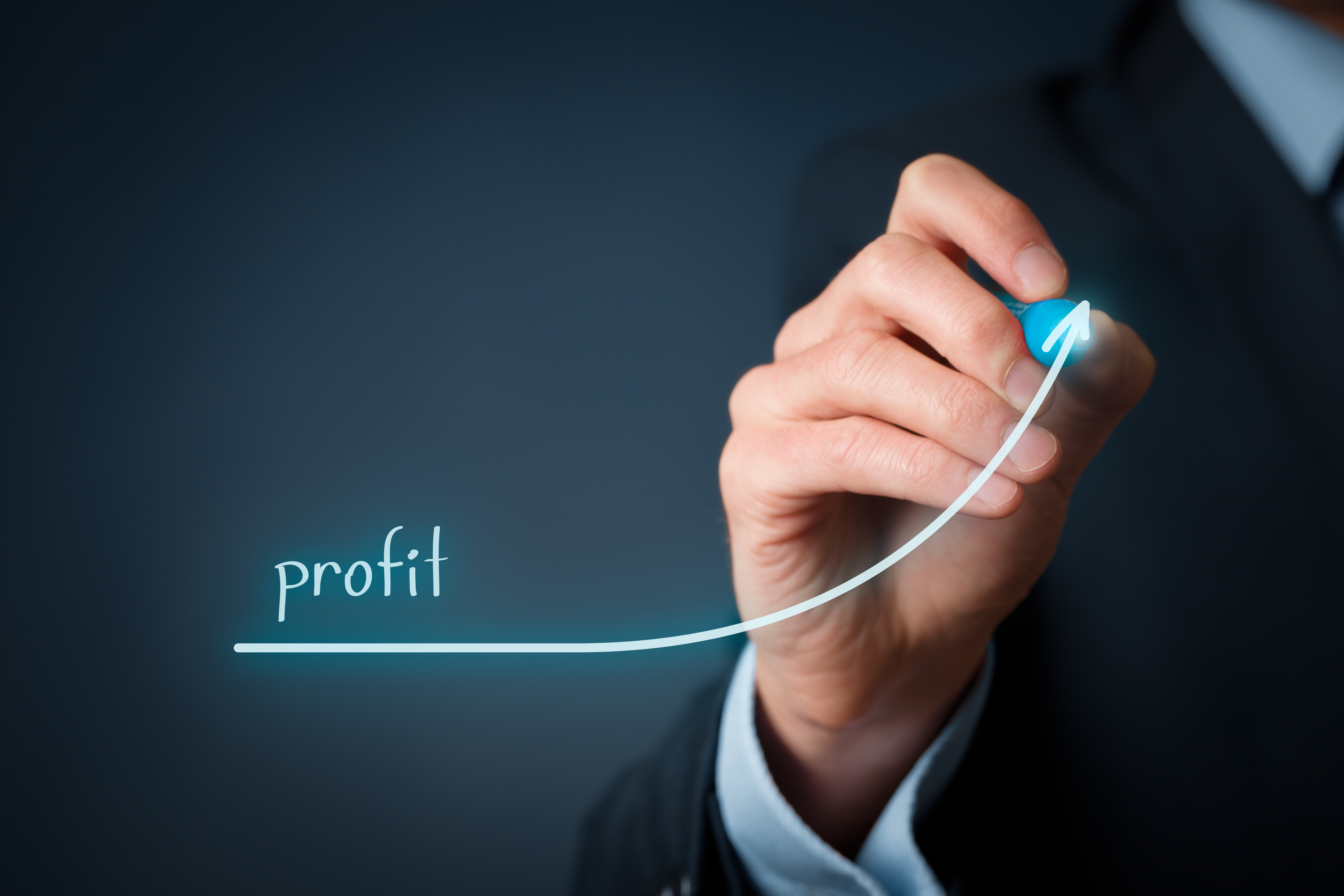 Hand drawing an upward trend line representing profit growth, symbolizing successful business performance and financial gains.