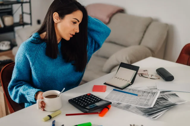 Property manager reviewing financial documents and expenses for rental properties across multiple counties.