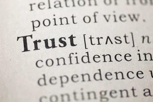 Close-up view of the word trust in a dictionary, representing Allegiant Management Group’s BBB A+ credibility.